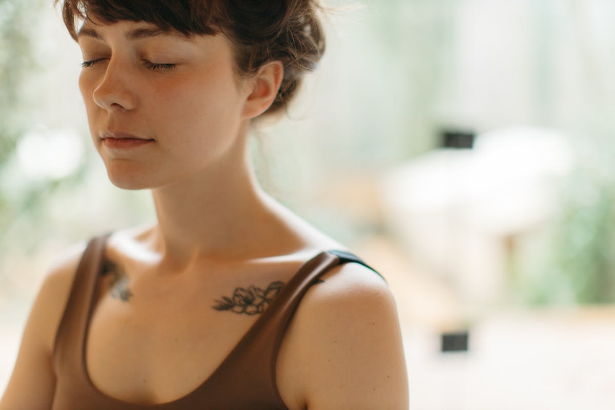 Woman in Sports Bra with Eyes Closed